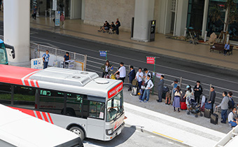 People wait for the shuttle bus